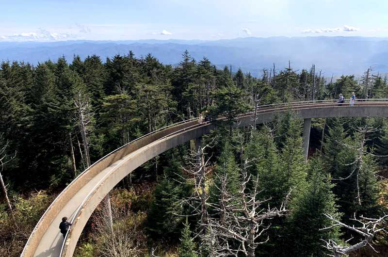 A view from clingman's dome overlooking the smoky mountains and a path leading up to the lookout spot.
